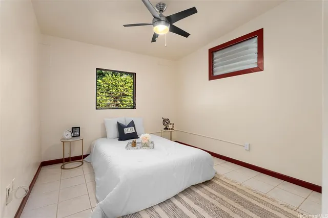 a bedroom with a bed and painting on the wall