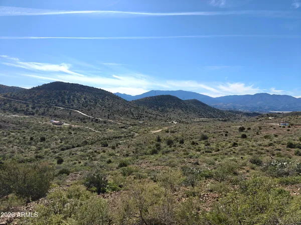 a view of a large mountain with mountains in the background