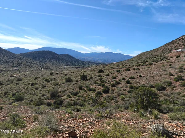 a view of a large mountain with mountains in the background