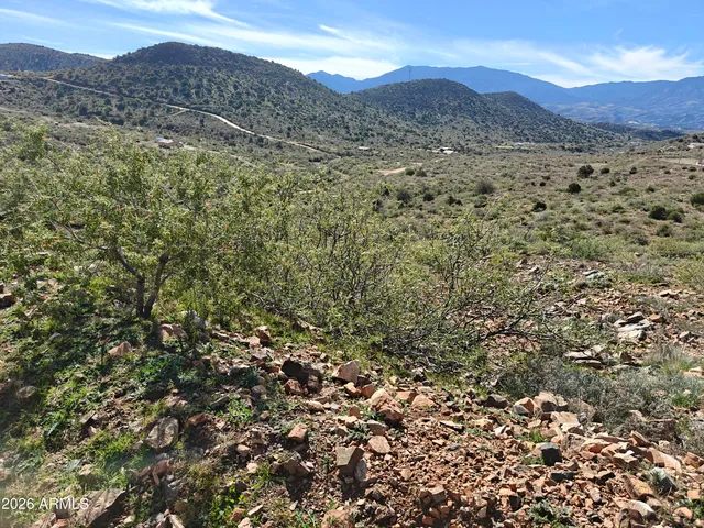 a view of a mountain range with lush green hillside