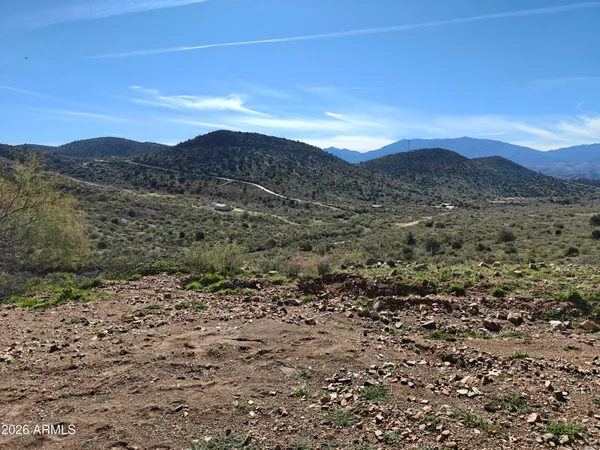 a view of a large mountain with mountains in the background