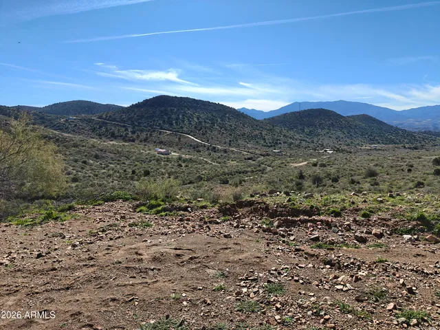 a view of a large mountain with mountains in the background