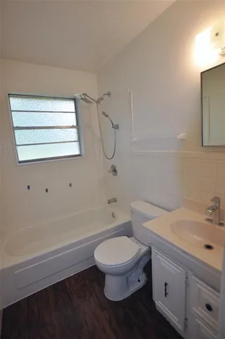 a bathroom with a toilet a sink and bathtub