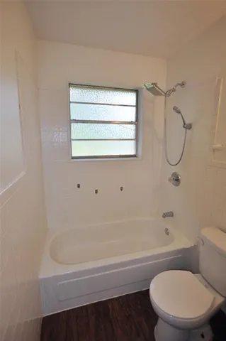 a bathroom with a toilet and a bathtub