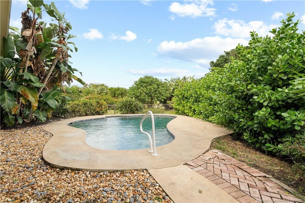 6323 Southeast Farmington Place Stuart, FL 34997 - Photo 32 of 46 Lush landscaping and fence provide pool privacy