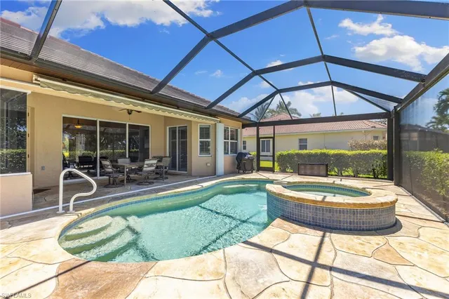 a patio with a table and chairs and potted plants