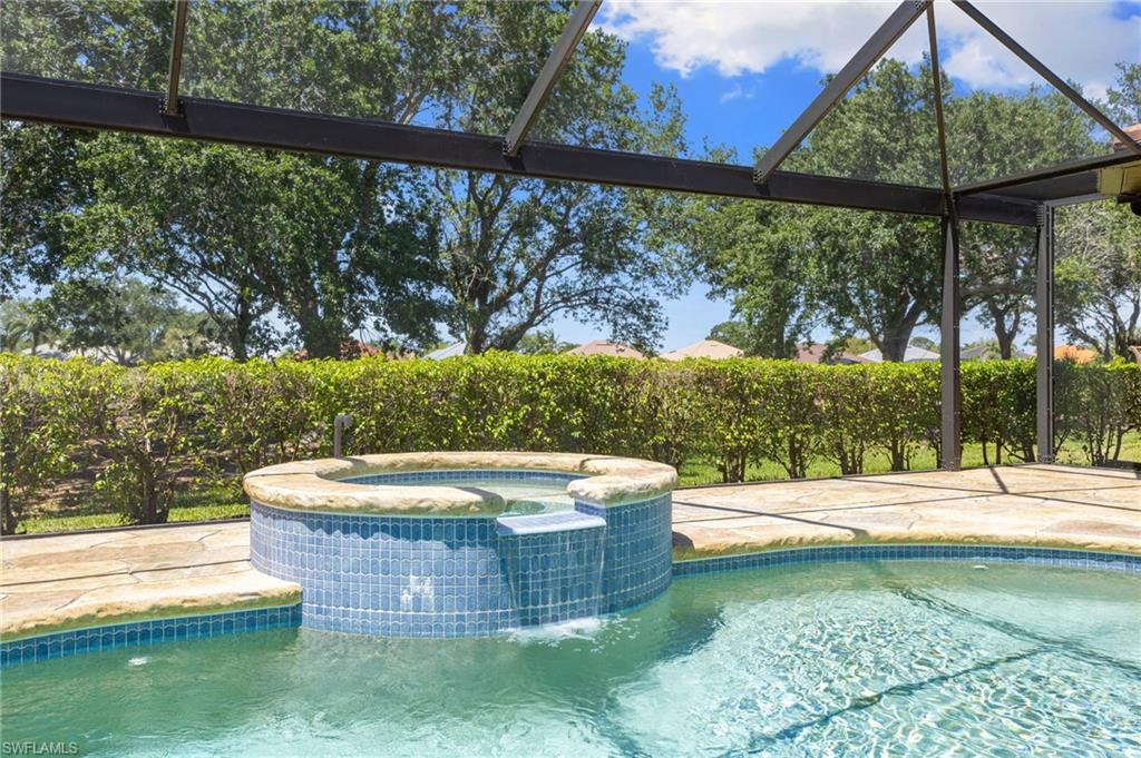 8886 Lely Island Circle Naples, FL 34113 - Photo 15 of 44 a view of a swimming pool with a patio