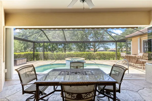a view of a patio with table and chairs and couches with wooden floor