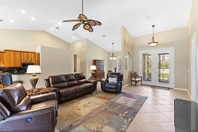 a living room with furniture ceiling fan and a rug