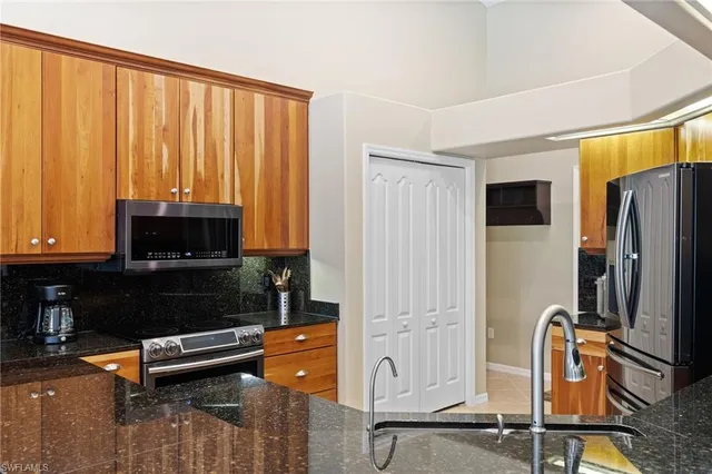 a living room with furniture a flat screen tv and a window