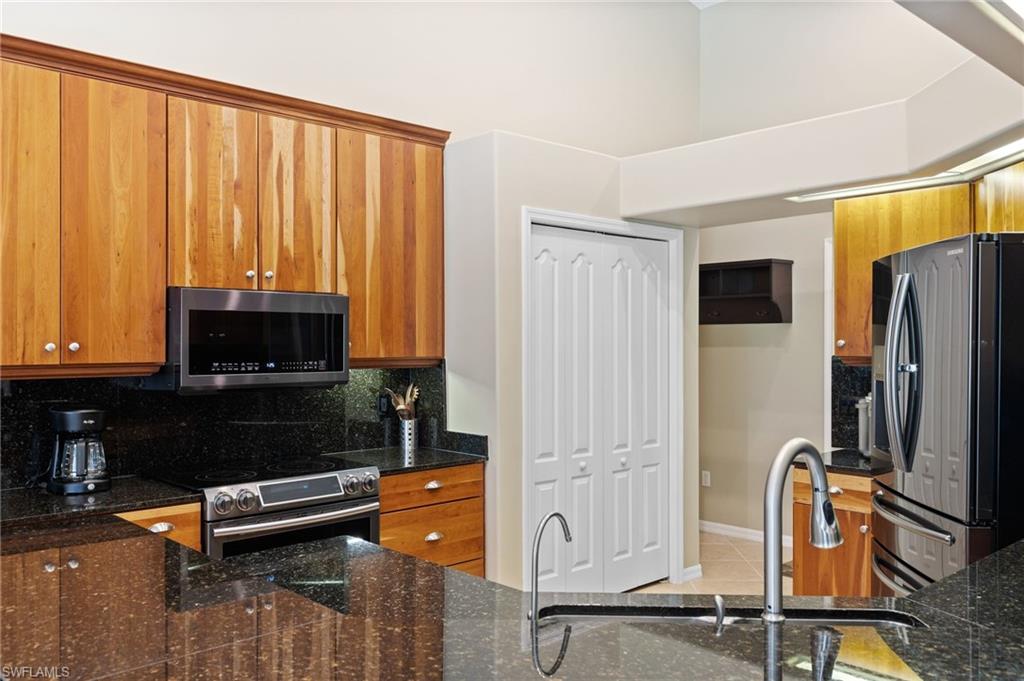 8886 Lely Island Circle Naples, FL 34113 - Photo 23 of 44 a living room with furniture a flat screen tv and a window