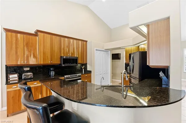 a kitchen with a sink a counter top space and cabinets
