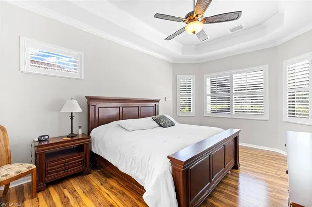 a spacious bedroom with a bed and a chandelier