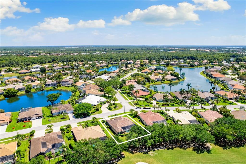 8886 Lely Island Circle Naples, FL 34113 - Photo 3 of 44 an aerial view of residential houses with outdoor space and trees