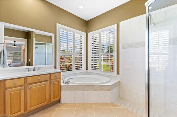 a spacious bathroom with sink shower and bathtub