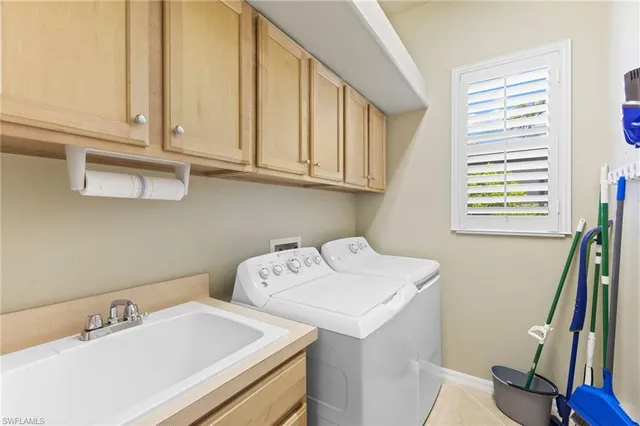 a bedroom with two beds and a chandelier