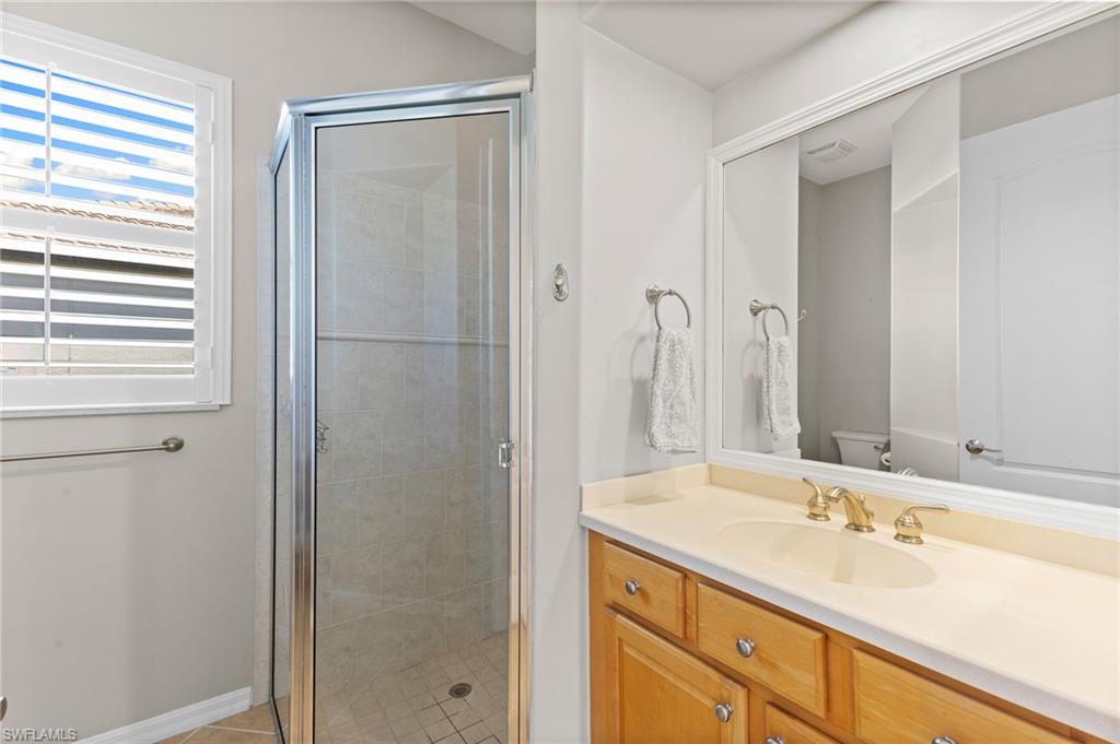 8886 Lely Island Circle Naples, FL 34113 - Photo 36 of 44 a bathroom with a sink and a mirror