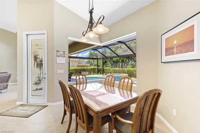 a dining room with furniture window and wooden floor