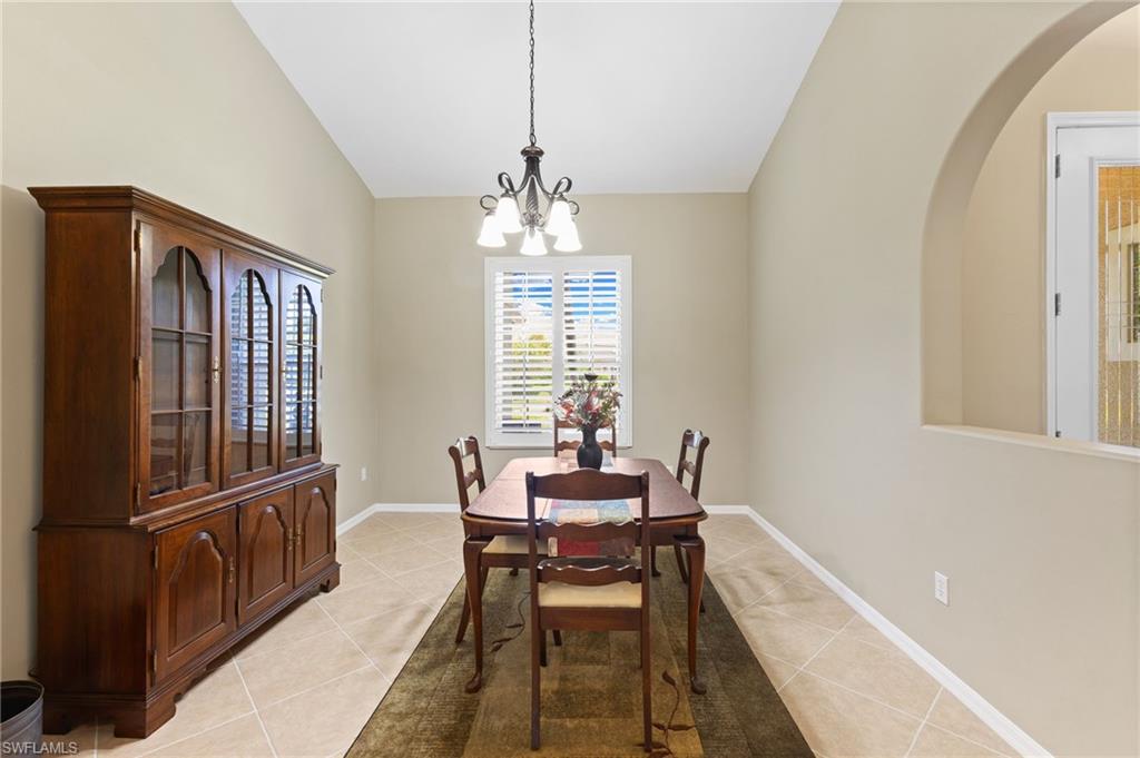 8886 Lely Island Circle Naples, FL 34113 - Photo 39 of 44 a dining room with furniture window and wooden floor