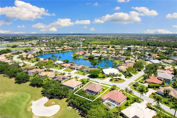 an aerial view of residential houses with outdoor space and river