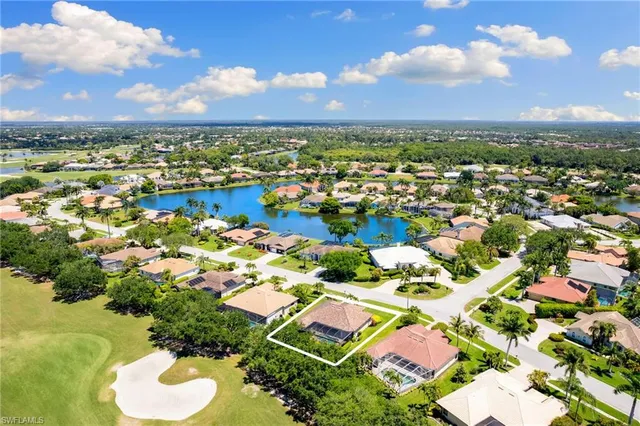 an aerial view of residential houses with outdoor space and river