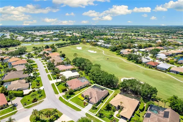 an aerial view of residential houses with outdoor space and river