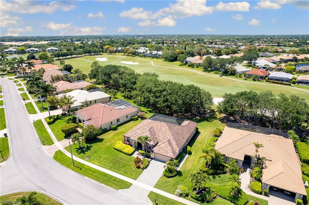 8886 Lely Island Circle Naples, FL 34113 - Photo 43 of 44 an aerial view of residential houses with outdoor space and river