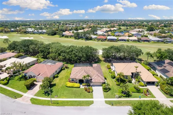 an aerial view of residential houses with outdoor space and lake view