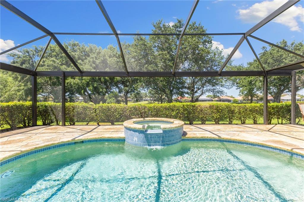8886 Lely Island Circle Naples, FL 34113 - Photo 8 of 44 a backyard of a house with table and chairs
