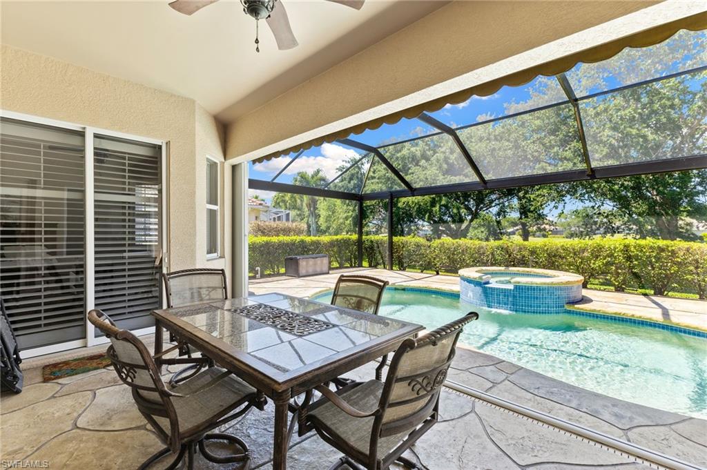8886 Lely Island Circle Naples, FL 34113 - Photo 9 of 44 a view of an outdoor dining space with a table and chairs