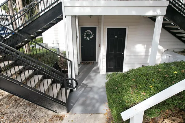 a view of a porch with wooden floor and floor to ceiling window