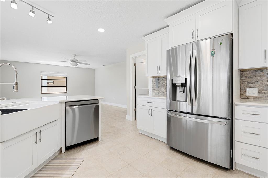 3929 North Sagomon Point Crystal River, FL 34428 - Photo 19 of 58 a kitchen with white cabinets and stainless steel appliances