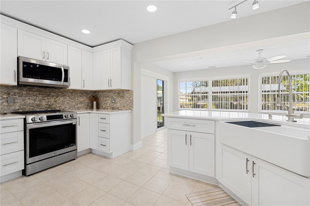 3929 North Sagomon Point Crystal River, FL 34428 - Photo 21 of 58 a kitchen with granite countertop white cabinets and stainless steel appliances