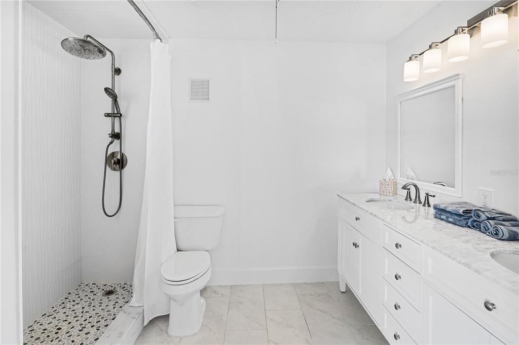 3929 North Sagomon Point Crystal River, FL 34428 - Photo 36 of 58 a bathroom with a granite countertop sink toilet and shower