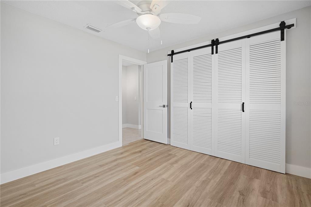 3929 North Sagomon Point Crystal River, FL 34428 - Photo 46 of 58 a view of an empty room with wooden floor and fan