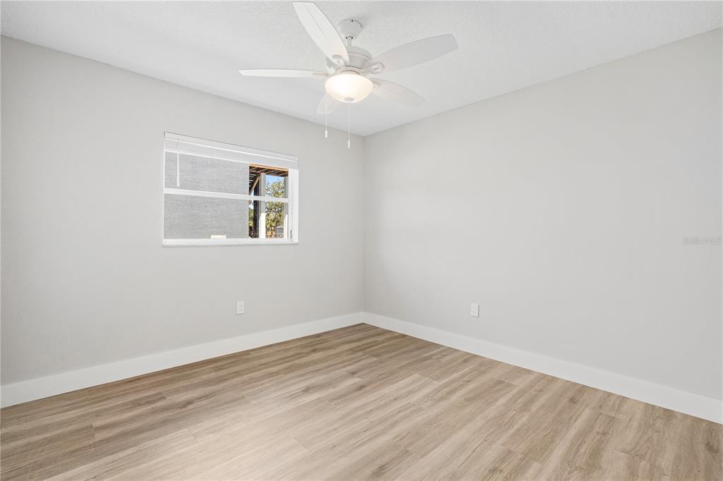 3929 North Sagomon Point Crystal River, FL 34428 - Photo 47 of 58 an empty room with wooden floor and windows