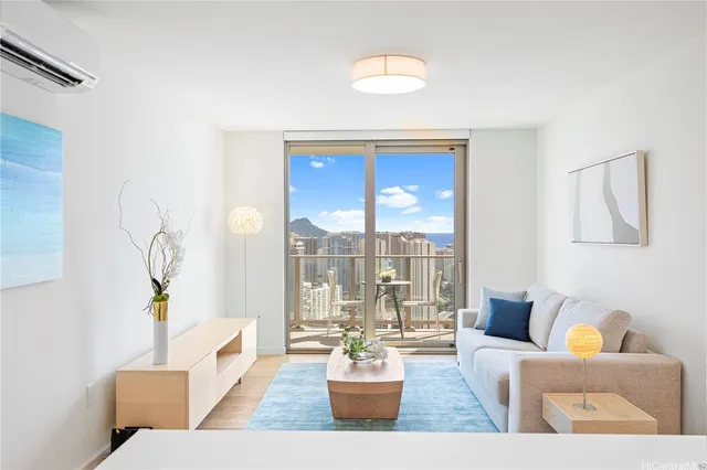 a living room with furniture and a potted plant
