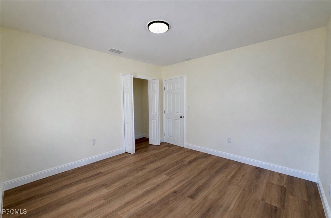261 Miramar Road Fort Myers, FL 33905 - Photo 14 of 24 a view of an empty room with wooden floor