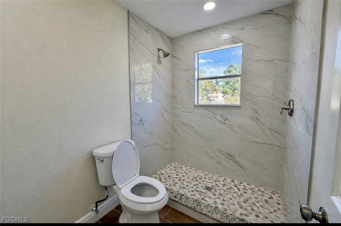 261 Miramar Road Fort Myers, FL 33905 - Photo 16 of 24 a white toilet sitting next to a shower