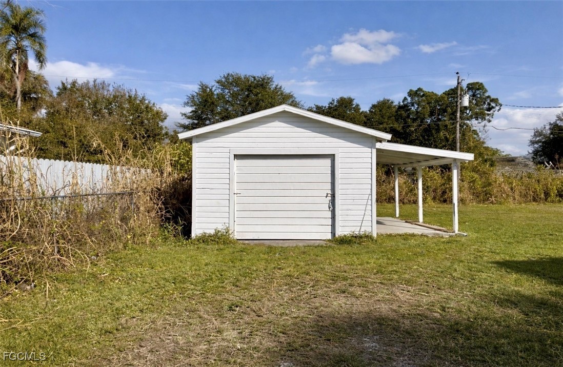 261 Miramar Road Fort Myers, FL 33905 - Photo 21 of 24 a front view of a house with a garden and yard