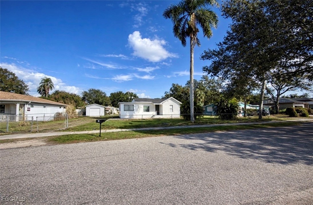 261 Miramar Road Fort Myers, FL 33905 - Photo 3 of 24 a view of road with house and trees in the background