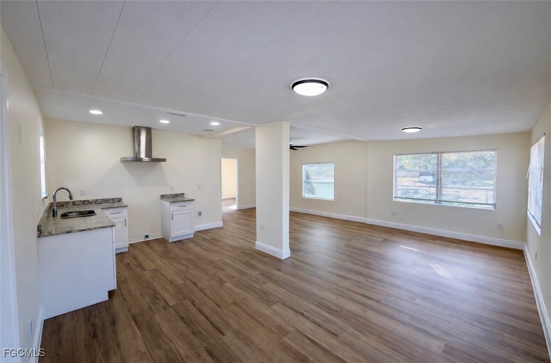 261 Miramar Road Fort Myers, FL 33905 - Photo 4 of 24 a kitchen with stainless steel appliances kitchen island granite countertop a stove and a refrigerator