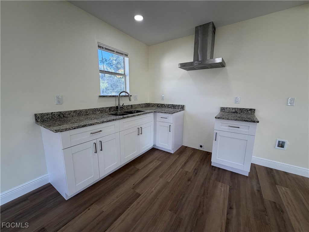 261 Miramar Road Fort Myers, FL 33905 - Photo 5 of 24 a kitchen with granite countertop a sink cabinets and wooden floor