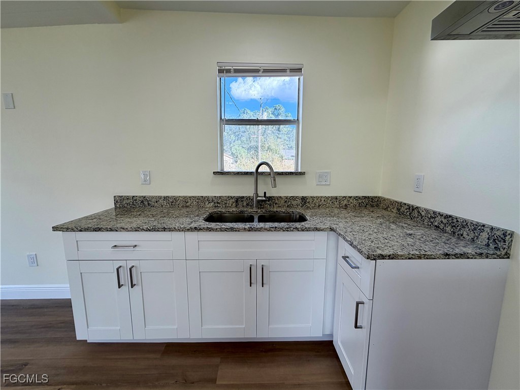 261 Miramar Road Fort Myers, FL 33905 - Photo 6 of 24 a kitchen with granite countertop white cabinets and a sink