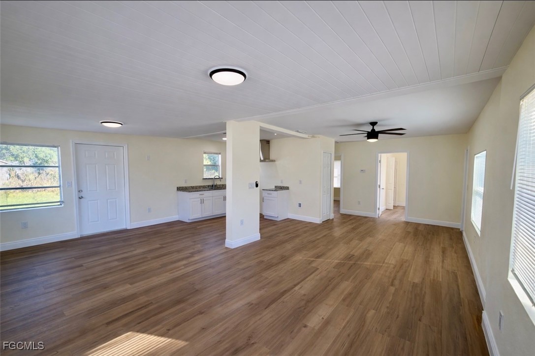 261 Miramar Road Fort Myers, FL 33905 - Photo 7 of 24 an empty room with wooden floor and windows