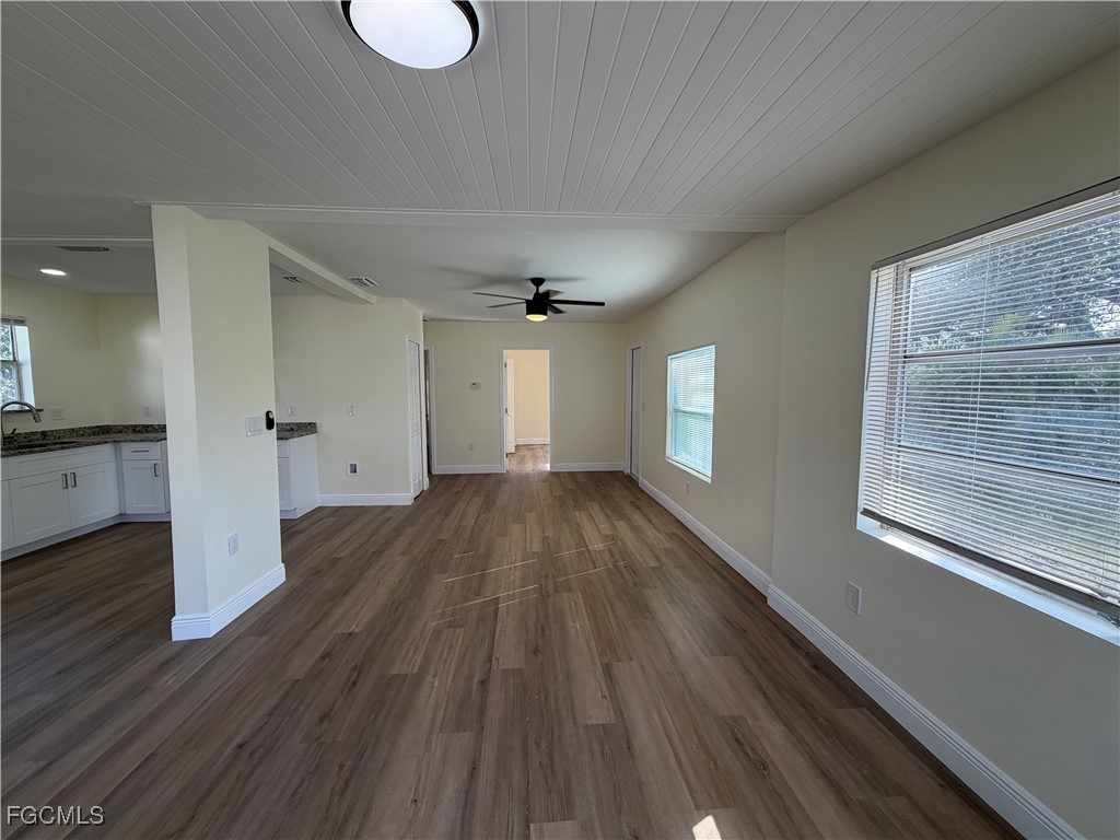 261 Miramar Road Fort Myers, FL 33905 - Photo 8 of 24 a view of empty room with wooden floor and fan