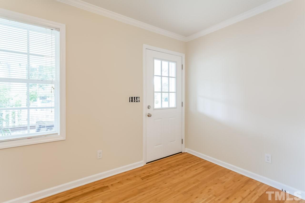 620 Brighton Road Raleigh, NC 27610 - Photo 12 of 25 an empty room with wooden floor and windows