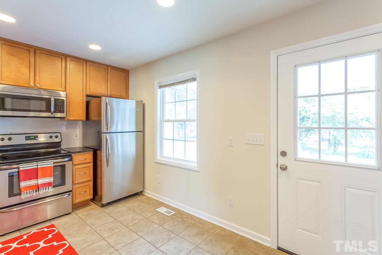 620 Brighton Road Raleigh, NC 27610 - Photo 15 of 25 a kitchen with stainless steel appliances granite countertop a refrigerator a stove a sink and a window