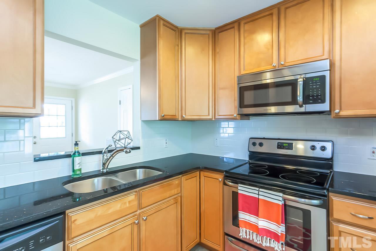 620 Brighton Road Raleigh, NC 27610 - Photo 17 of 25 a kitchen with stainless steel appliances granite countertop a sink stove and microwave