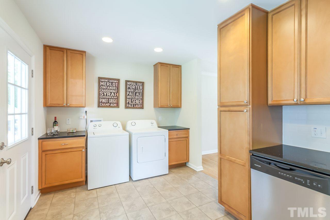 620 Brighton Road Raleigh, NC 27610 - Photo 18 of 25 a utility room with cabinets washer and dryer